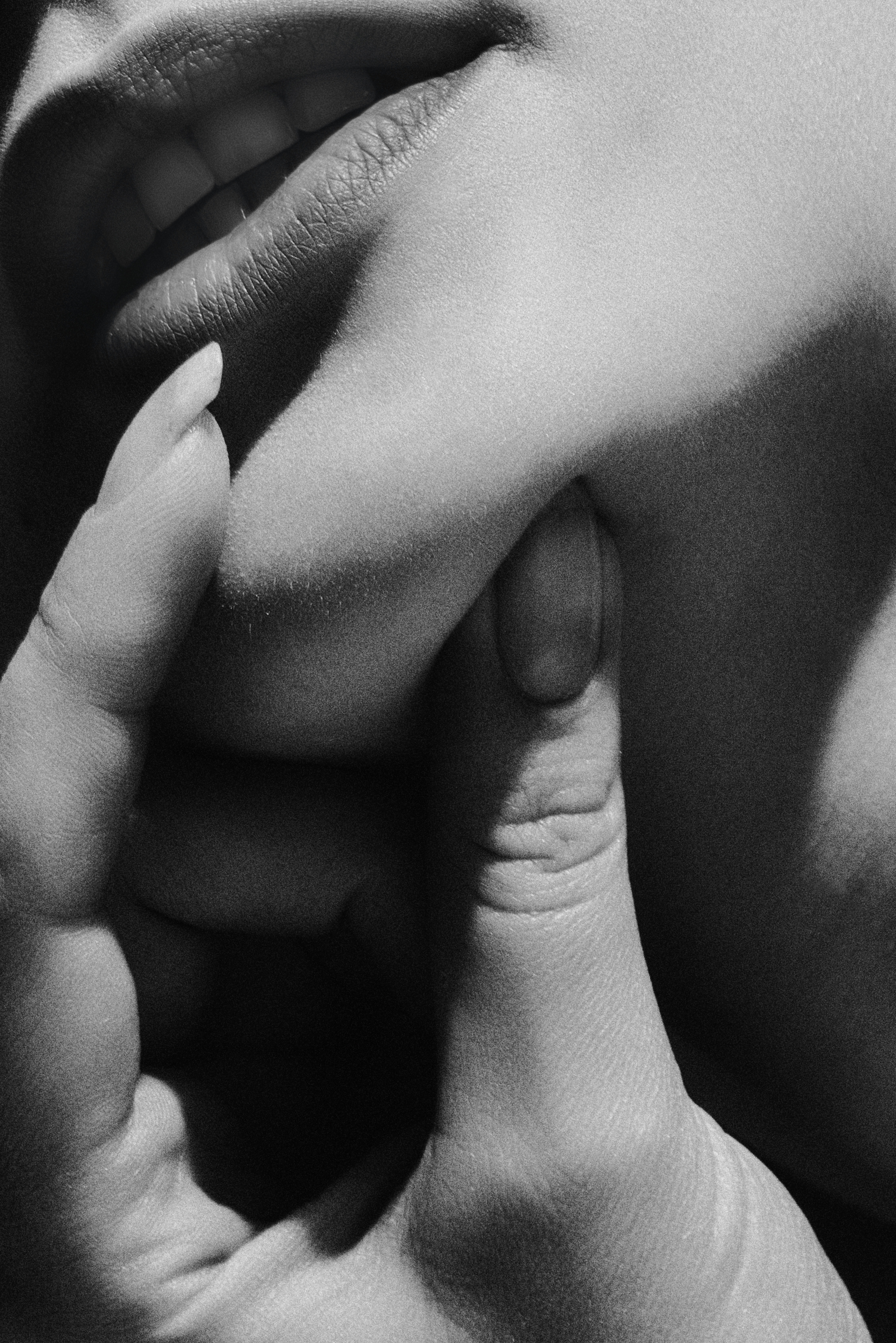 grayscale-photo-of-woman-holding-lips-1257359